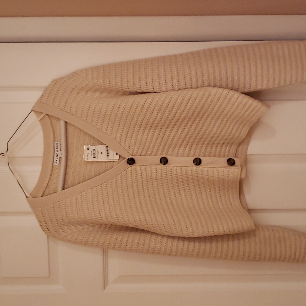 Woman's long sleeve button front cardigan.  Never worn.